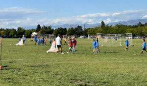 Photo of tryouts with players and soccer nets in a park