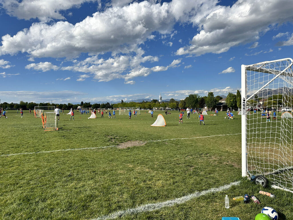 Players outside playing soccer in a large park